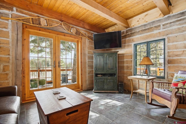 living area with a healthy amount of sunlight, wood ceiling, beam ceiling, and french doors