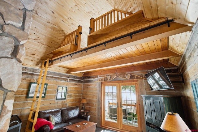 living area featuring vaulted ceiling with beams, wood ceiling, and french doors