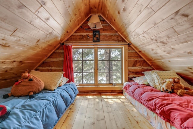 bedroom featuring lofted ceiling, hardwood / wood-style flooring, wood ceiling, and wood walls