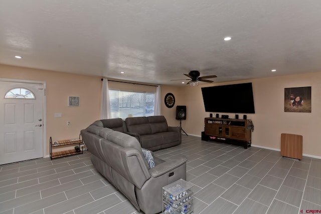 living area with ceiling fan, baseboards, and recessed lighting