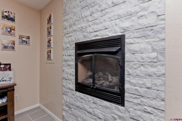 interior details featuring a fireplace and baseboards