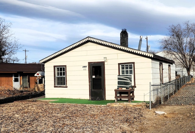 rear view of house with fence