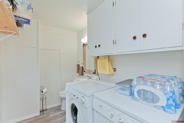 laundry area featuring laundry area, independent washer and dryer, and light wood-style flooring