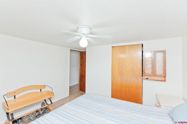 bedroom with a ceiling fan and light wood-style flooring