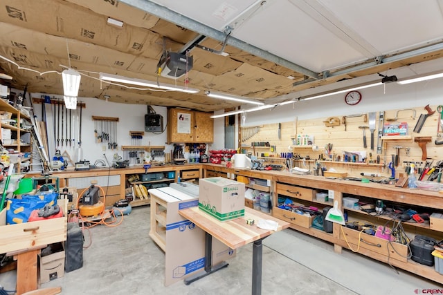 garage with a workshop area and a garage door opener