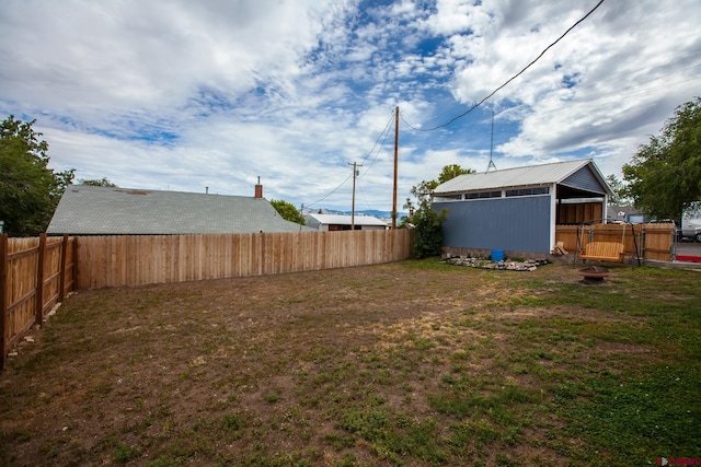 view of yard featuring an outdoor structure and a fenced backyard