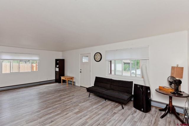 living room featuring a baseboard radiator and light wood-style flooring