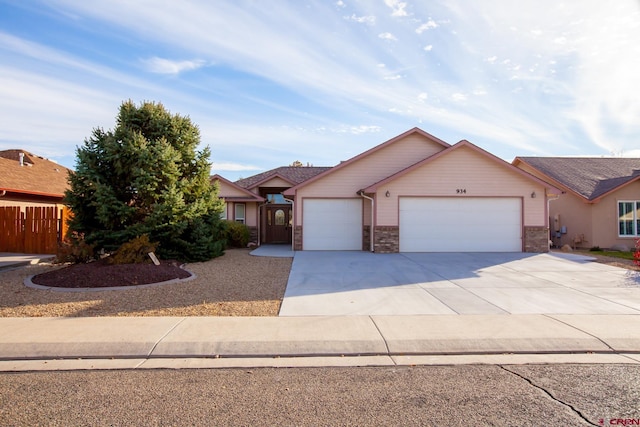 single story home featuring an attached garage, driveway, fence, and brick siding