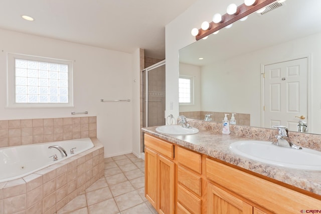 bathroom featuring a whirlpool tub, a stall shower, a sink, and visible vents