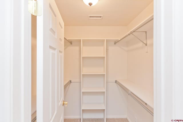 walk in closet featuring carpet and visible vents