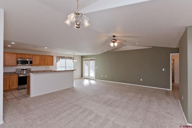 kitchen with lofted ceiling, recessed lighting, light carpet, open floor plan, and appliances with stainless steel finishes