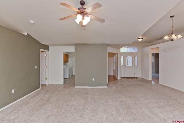 unfurnished living room with light carpet, separate washer and dryer, ceiling fan with notable chandelier, and baseboards