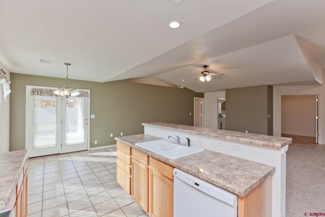 kitchen featuring light brown cabinets, a kitchen island with sink, a sink, vaulted ceiling, and dishwasher