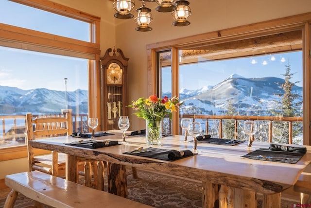 dining space with a mountain view, a chandelier, and a wealth of natural light