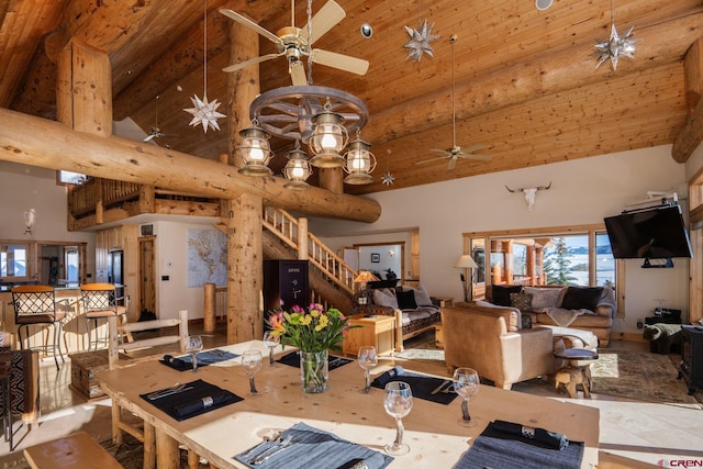 dining space with high vaulted ceiling, ceiling fan, stairway, and beam ceiling