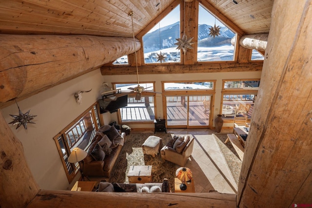 living room with wooden ceiling and high vaulted ceiling