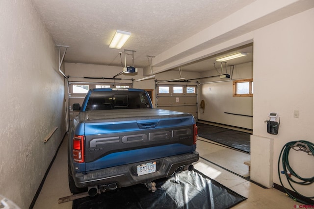 garage with a textured wall and a garage door opener