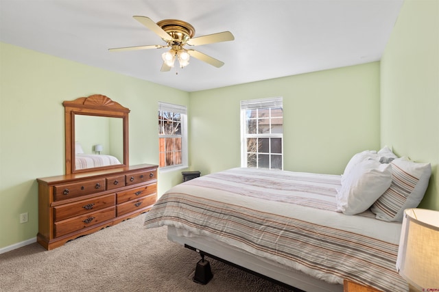 carpeted bedroom featuring a ceiling fan and baseboards