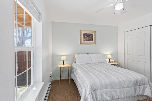 bedroom featuring carpet floors, a baseboard heating unit, baseboards, and a ceiling fan