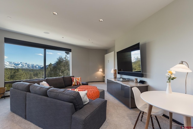 living area featuring light carpet and recessed lighting