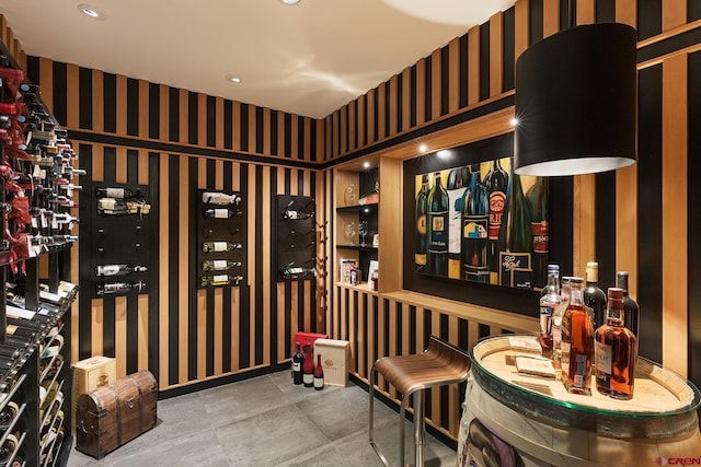 wine room featuring wallpapered walls and recessed lighting