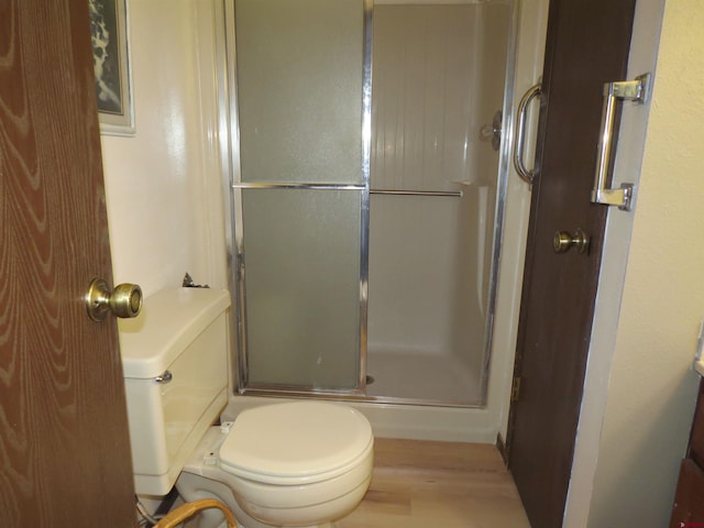 full bath with a shower with shower door and toilet