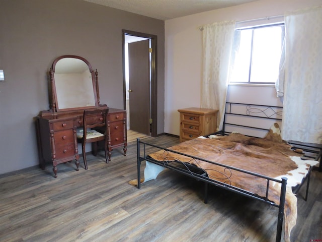 bedroom featuring wood finished floors