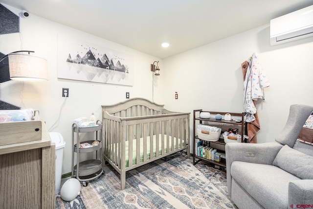 bedroom with a crib and an AC wall unit