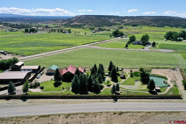 birds eye view of property with a mountain view and a rural view