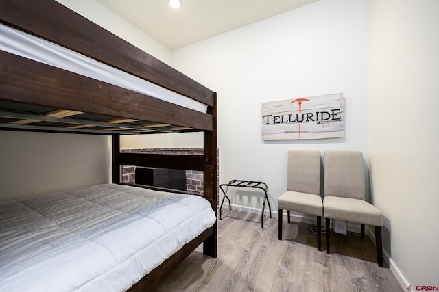 bedroom featuring wood finished floors and baseboards