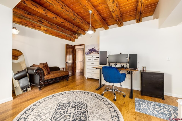 office area featuring beam ceiling, wood finished floors, wood ceiling, and baseboards