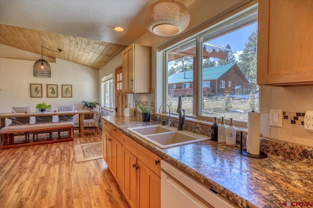 kitchen featuring decorative light fixtures, light wood-style floors, vaulted ceiling, a sink, and wooden ceiling