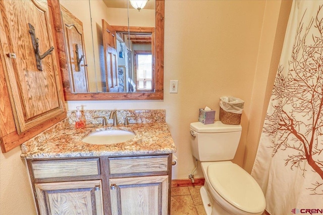 full bath featuring toilet, baseboards, and vanity