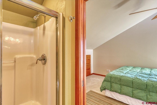 carpeted bedroom featuring lofted ceiling, ceiling fan, and baseboards