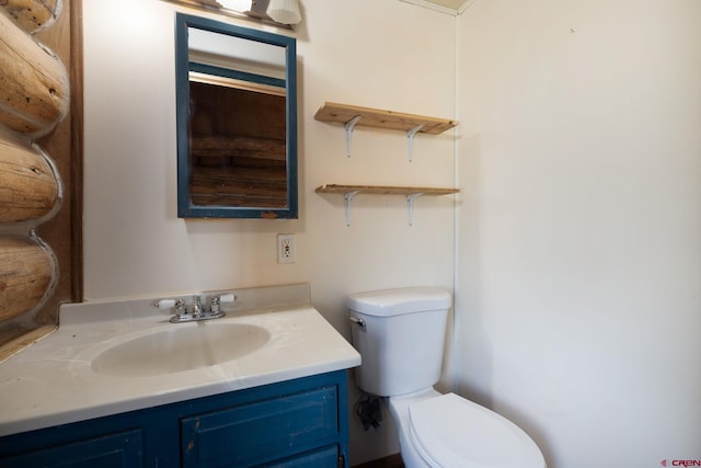 half bathroom with vanity and toilet