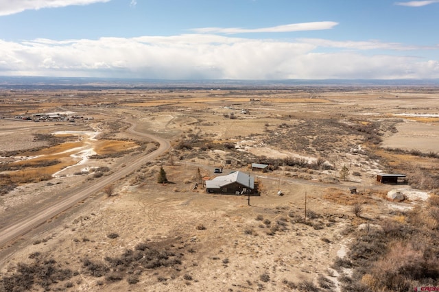 birds eye view of property featuring a rural view and a desert view