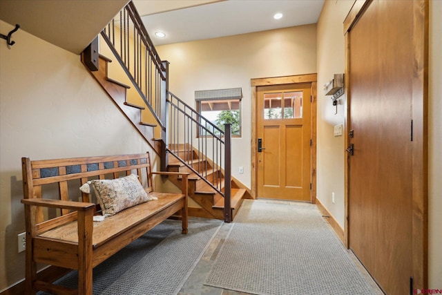 carpeted entryway with baseboards, stairway, and recessed lighting