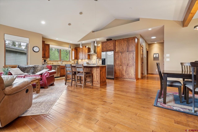 living area featuring recessed lighting, vaulted ceiling, and light wood finished floors