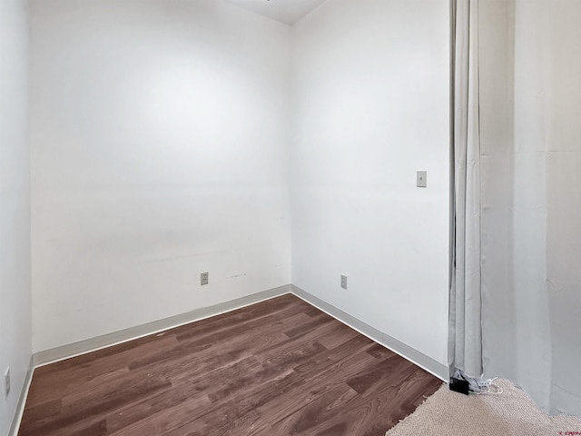 empty room with dark wood-style flooring