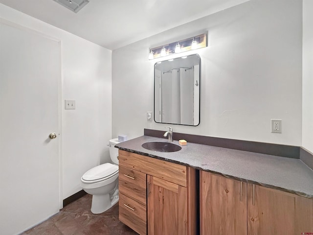 half bathroom featuring visible vents, vanity, and toilet