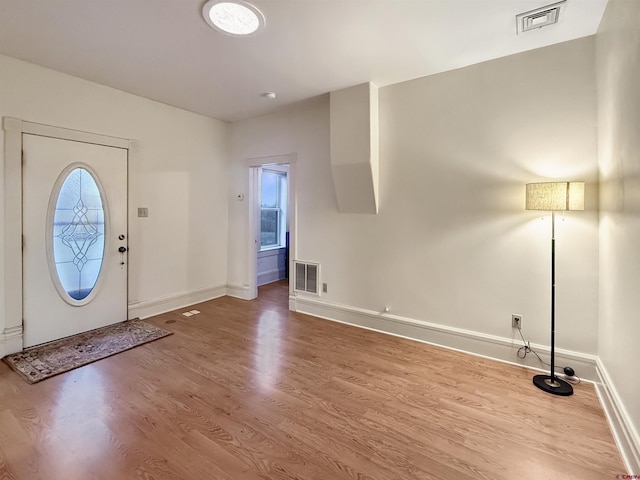 entryway featuring wood finished floors, visible vents, and baseboards