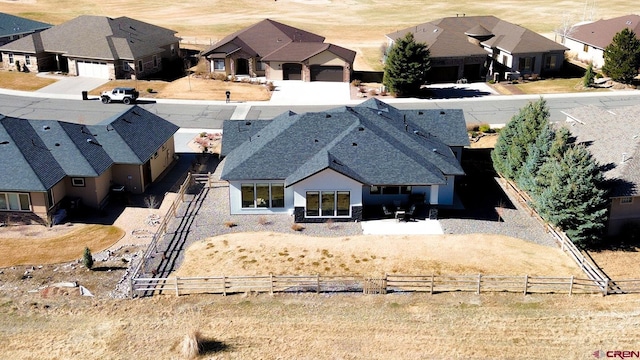 birds eye view of property with a residential view