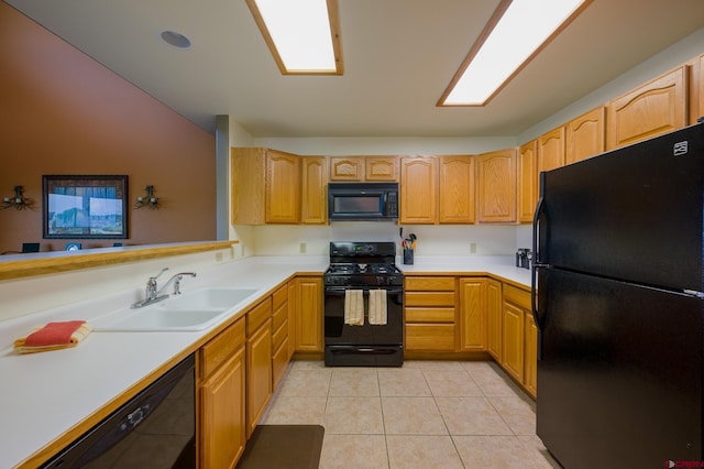 kitchen with light tile patterned floors, black appliances, a sink, and light countertops