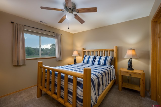 carpeted bedroom with a ceiling fan, visible vents, and baseboards