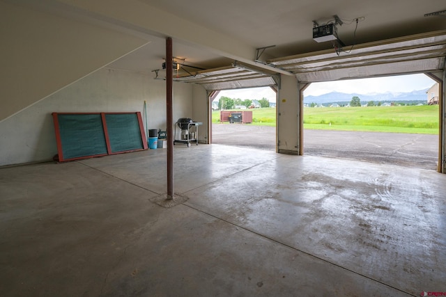 garage with a mountain view and a garage door opener