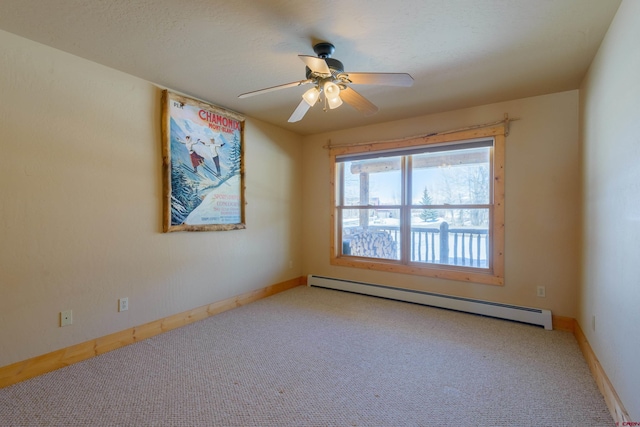 empty room featuring carpet floors, baseboards, baseboard heating, and a ceiling fan