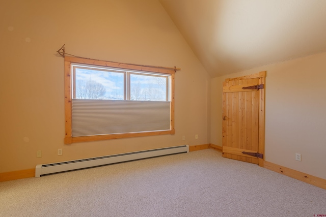 carpeted empty room featuring lofted ceiling, a baseboard radiator, and baseboards