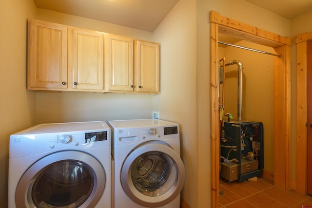 laundry area with cabinet space, tile patterned flooring, a heating unit, and washing machine and clothes dryer