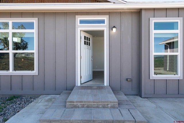 view of exterior entry featuring board and batten siding