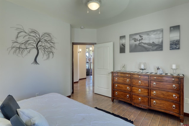 bedroom with ceiling fan and dark wood finished floors